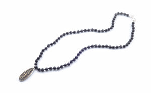 Beautiful authentic Thai teardrop amulet on 30" mala necklace of 8mm polished black onyx semi-precious stones hand-knotted with natural silk thread; adorned with .925 sterling silver hand-pressed Jai Style charm and toggle clasp.