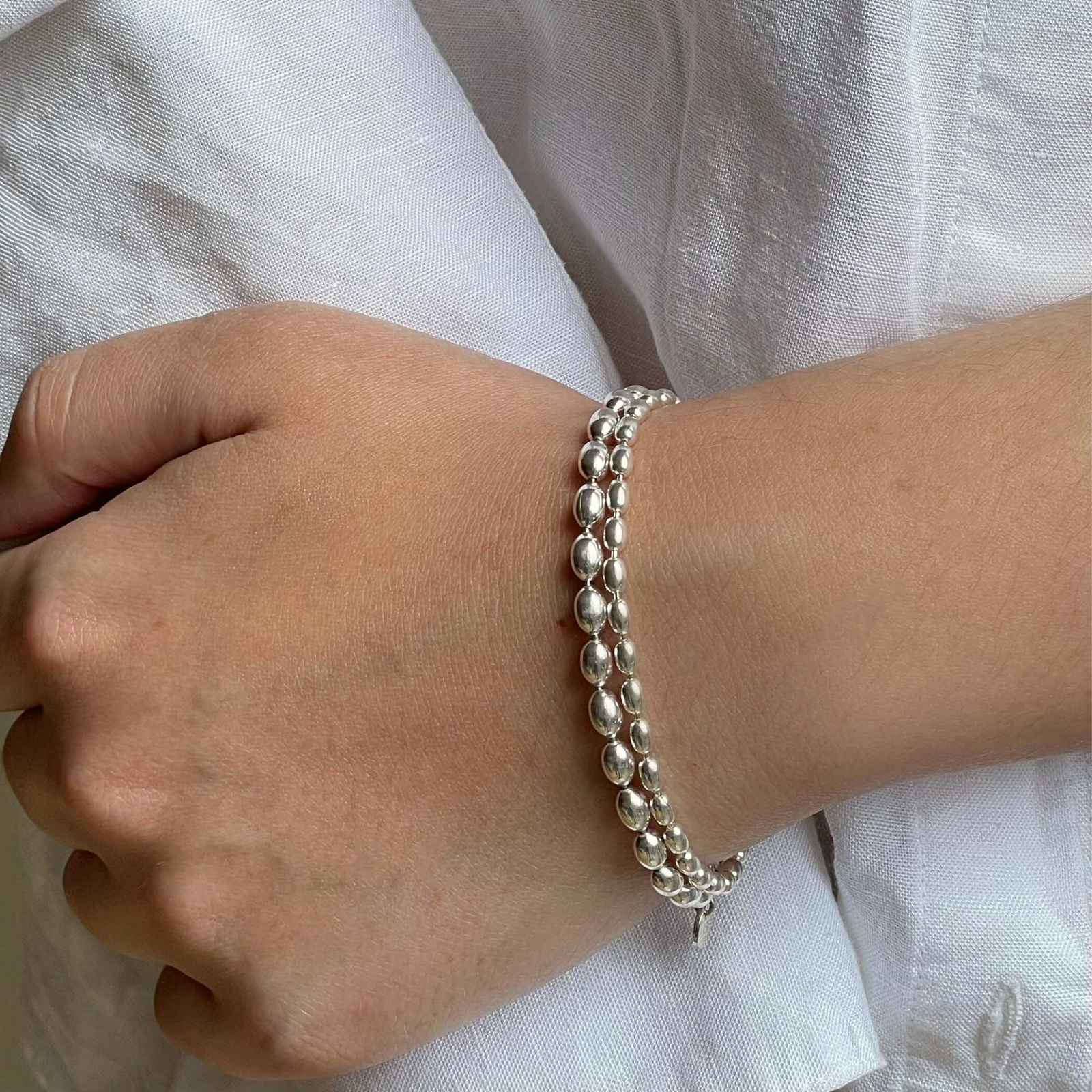 Jai Style simple, elegant, 7" handmade solid sterling silver 4mm and 6mm rice pearl bracelets with Jai Style embossed charm.