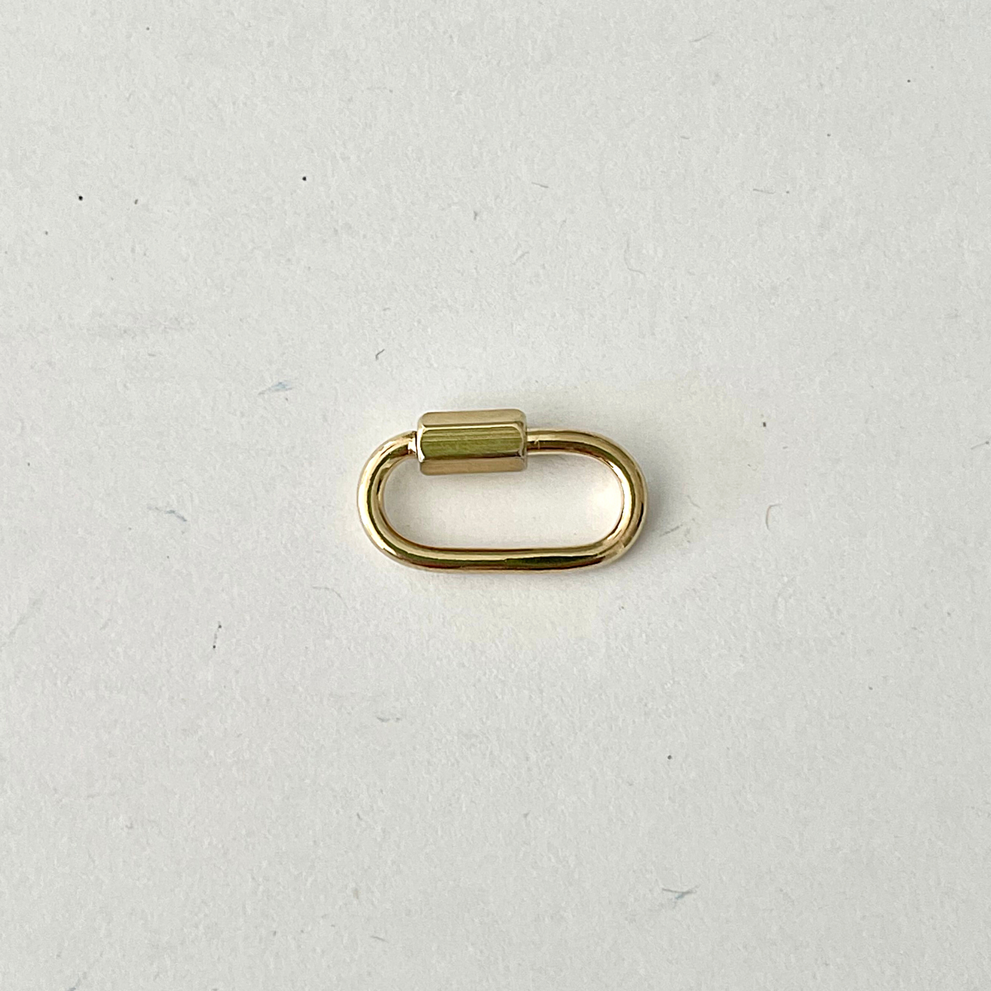Beautiful and versatile 14K gold plate carabiner charm ring. Wear it on the front, hide it on the back, or personalize your necklace with multiple charms or a pendant.