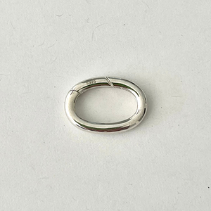 Beautiful and versatile .925 solid sterling silver oval charm ring and clasp. Wear it on the front, hide it on the back, or personalize your necklace with multiple charms or a pendant.