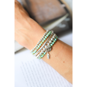 Beautiful 4mm Turquoise semi-precious stone bracelets. Adorned with .925 sterling silver ball beads. Also available with sterling silver amulet hand-cast in .925 sterling silver. Stretch bracelet measures 18.4 cm (7 1/4 in.).