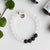 Beautiful 8mm matte clear quartz semi-precious stone blessing bracelet featuring 4 lava stones and your choice of essential oils for love, protection, grounding and/or grief; adorned with sterling silver ball bead and charm, stretch, measures 18.4 cm