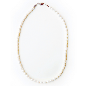 Beautiful handcrafted 16" necklace of organic freshwater 6mm rice pearls. Elegant on its own and perfect for layering. Adorned with .925 sterling silver Jai Style hand-embossed charm and lobster clasp.