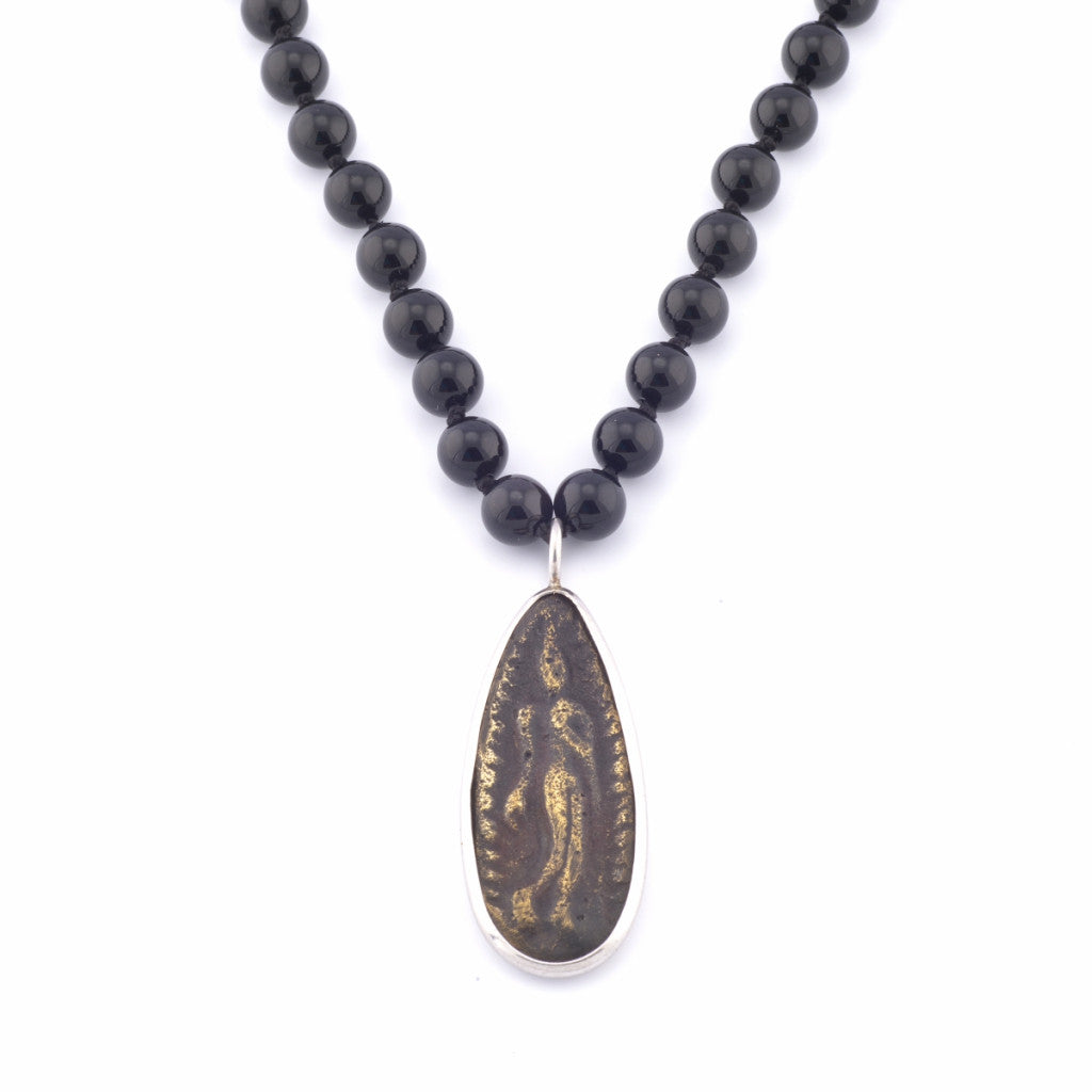 Beautiful authentic Thai teardrop amulet on 30" mala necklace of 8mm polished black onyx semi-precious stones hand-knotted with natural silk thread; adorned with .925 sterling silver hand-pressed Jai Style charm and toggle clasp.