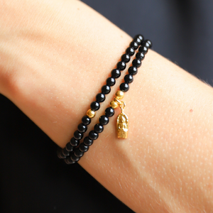 Beautiful polished 4mm black onyx semi-precious stone bracelets. Adorned with gold vermeil ball beads. Also available with gold vermeil amulet hand-cast in .925 sterling silver and plated in 22K gold. Stretch bracelet measures 18.4 cm (7 1/4 in.).