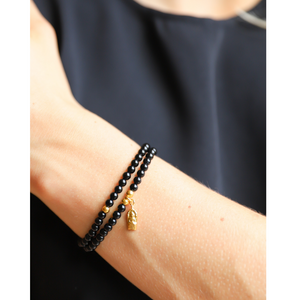 Beautiful polished 4mm black onyx semi-precious stone bracelets. Adorned with gold vermeil ball beads. Also available with gold vermeil amulet hand-cast in .925 sterling silver and plated in 22K gold. Stretch bracelet measures 18.4 cm (7 1/4 in.).