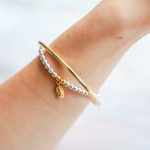 Beautiful sterling silver 4mm ball bead bracelet. Adorned with gold vermeil amulet Amulet os hand-cast in .925 sterling silver and plated in 22K gold. Stretch bracelet measures 18.4 cm (7 1/4 in.).