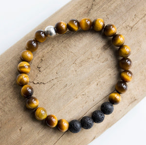 Beautiful 8mm tiger's eye semi-precious stone blessing bracelet featuring 4 lava stones and your choice of essential oils for love, protection, grounding and/or grief; adorned with sterling silver ball bead and charm, stretch, measures 20.3 cm